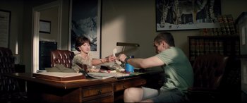 Movie still from “Richard Jewell” (2019), directed by Clint Eastwood – A man and a woman sitting at a desk; Medium shot, Over the shoulder angle