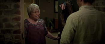 Movie still from “Richard Jewell” (2019), directed by Clint Eastwood – An older woman holding a door knob to a man; Medium shot, Over the shoulder angle