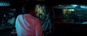 Movie still from “Richard Jewell” (2019), directed by Clint Eastwood – A man and a woman are standing in front of a painting; Medium shot, Over the shoulder angle