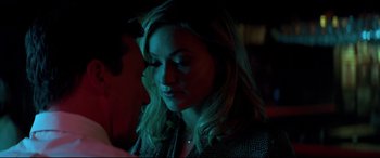 Movie still from “Richard Jewell” (2019), directed by Clint Eastwood – A woman with long blonde hair sitting in a dark room; Close Up shot, Over the shoulder angle