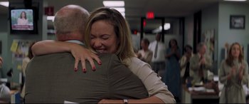 Movie still from “Richard Jewell” (2019), directed by Clint Eastwood – A woman is hugging a man in a room; Medium shot, Over the shoulder angle