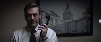 Movie still from “Richard Jewell” (2019), directed by Clint Eastwood – A man holding a phone up to his ear; Close Up shot, High angle