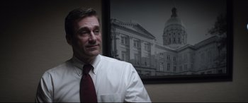 Movie still from “Richard Jewell” (2019), directed by Clint Eastwood – A man wearing a white shirt and a red tie; Close Up shot, Low angle