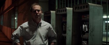 Movie still from “Richard Jewell” (2019), directed by Clint Eastwood – A man standing in front of three phone booths; Close Up shot, Low angle