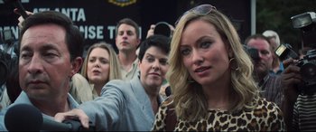 Movie still from “Richard Jewell” (2019), directed by Clint Eastwood – A group of people taking a picture with a cell phone; Close Up shot, Over the shoulder angle