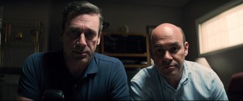 Movie still from “Richard Jewell” (2019), directed by Clint Eastwood – Two men sitting next to each other in front of a television; Close Up shot, Low angle