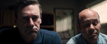 Movie still from “Richard Jewell” (2019), directed by Clint Eastwood – A person sitting in front of a painting; Close Up shot, Low angle