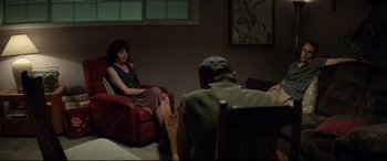 Movie still from “Richard Jewell” (2019), directed by Clint Eastwood – A woman sitting on a chair in front of a man; Wide shot, Over the shoulder angle