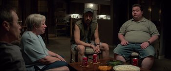 Movie still from “Richard Jewell” (2019), directed by Clint Eastwood – A group of people sitting around a table with drinks; Medium shot, High angle