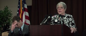 Movie still from “Richard Jewell” (2019), directed by Clint Eastwood – An older woman standing at a podium with microphones; Close Up shot, Low angle