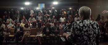 Movie still from “Richard Jewell” (2019), directed by Clint Eastwood – A group of people sitting in front of microphones; Wide shot, Low angle