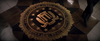 Movie still from “Richard Jewell” (2019), directed by Clint Eastwood – The federal bureau of investigation logo; Wide shot, Overhead angle