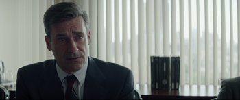 Movie still from “Richard Jewell” (2019), directed by Clint Eastwood – A person wearing a suit and tie; Close Up shot, Over the shoulder angle