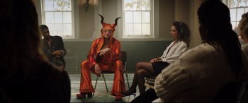 Movie still from “Rocketman” (2019), directed by Dexter Fletcher – A man and a woman dressed as a devil; Wide shot, Over the shoulder angle