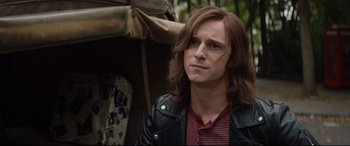 Movie still from “Rocketman” (2019), directed by Dexter Fletcher – A person with long hair; Close Up shot, Over the shoulder angle