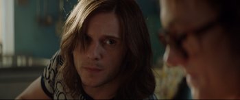 Movie still from “Rocketman” (2019), directed by Dexter Fletcher – A person with long brown hair; Close Up shot, Over the shoulder angle