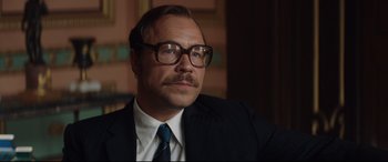 Movie still from “Rocketman” (2019), directed by Dexter Fletcher – A person wearing glasses and a suit; Close Up shot, Low angle