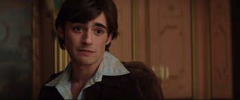 Movie still from “Rocketman” (2019), directed by Dexter Fletcher – A person wearing a brown jacket; Close Up shot, Over the shoulder angle