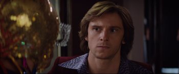 Movie still from “Rocketman” (2019), directed by Dexter Fletcher – A person with long hair; Close Up shot, Over the shoulder angle