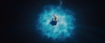 Movie still from “Rocketman” (2019), directed by Dexter Fletcher – An aerial view of a person floating in the water; Extreme Wide shot, Overhead angle