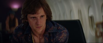 Movie still from “Rocketman” (2019), directed by Dexter Fletcher – A person wearing a blue shirt; Close Up shot, Over the shoulder angle