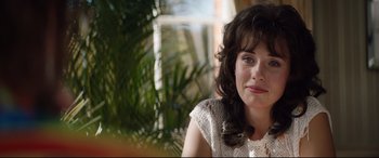 Movie still from “Rocketman” (2019), directed by Dexter Fletcher – A person sitting in front of a window; Close Up shot, Over the shoulder angle