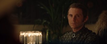 Movie still from “Rocketman” (2019), directed by Dexter Fletcher – A person sitting at a table; Close Up shot, Over the shoulder angle