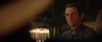 Movie still from “Rocketman” (2019), directed by Dexter Fletcher – A man sitting at a table with a glass of beer; Close Up shot, Over the shoulder angle