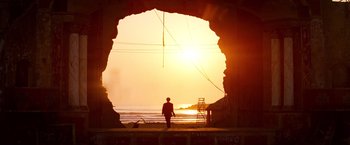 Movie still from “Romeo + Juliet” (1996), directed by Baz Luhrmann – A man standing in front of a large rock arch; Extreme Wide shot, Low angle