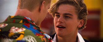 Movie still from “Romeo + Juliet” (1996), directed by Baz Luhrmann – Two young men talking to each other outside; Close Up shot, Over the shoulder angle