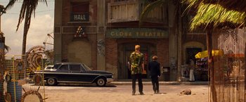 Movie still from “Romeo + Juliet” (1996), directed by Baz Luhrmann – Two people standing in front of a theatre; Wide shot, Low angle