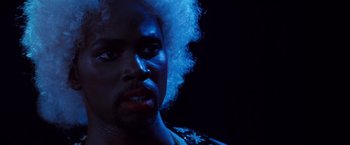 Movie still from “Romeo + Juliet” (1996), directed by Baz Luhrmann – A person with blue hair; Close Up shot, Low angle