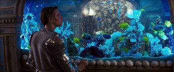 Movie still from “Romeo + Juliet” (1996), directed by Baz Luhrmann – A man standing in front of a fish tank; Medium shot, Over the shoulder angle