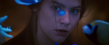 Movie still from “Romeo + Juliet” (1996), directed by Baz Luhrmann – A girl with blue eyes and a blue dot on her nose; Extreme Close Up shot, Low angle