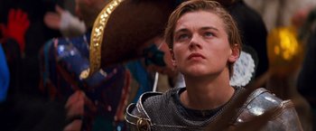 Movie still from “Romeo + Juliet” (1996), directed by Baz Luhrmann – A young man wearing a chain mail outfit; Close Up shot, Low angle