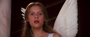 Movie still from “Romeo + Juliet” (1996), directed by Baz Luhrmann – A person wearing a white shirt; Close Up shot, Low angle