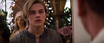 Movie still from “Romeo + Juliet” (1996), directed by Baz Luhrmann – A young man wearing a medieval style shirt; Close Up shot, Over the shoulder angle