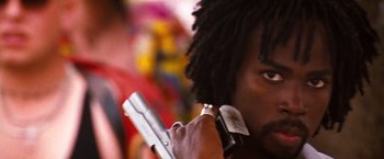 Movie still from “Romeo + Juliet” (1996), directed by Baz Luhrmann – A man holding a gun up to his face; Close Up shot, Low angle