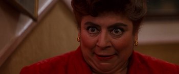 Movie still from “Romeo + Juliet” (1996), directed by Baz Luhrmann – An older woman with a surprised look on her face; Close Up shot, Low angle