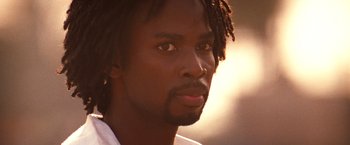 Movie still from “Romeo + Juliet” (1996), directed by Baz Luhrmann – A person with dreadlocks; Close Up shot, Low angle
