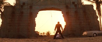 Movie still from “Romeo + Juliet” (1996), directed by Baz Luhrmann – A man standing in front of an opening in a wall; Wide shot, Low angle