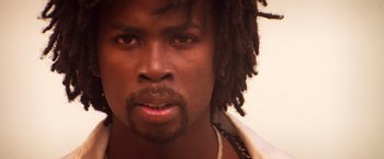 Movie still from “Romeo + Juliet” (1996), directed by Baz Luhrmann – A person with dreadlocks; Close Up shot, Low angle