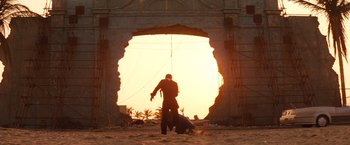 Movie still from “Romeo + Juliet” (1996), directed by Baz Luhrmann – A man standing in front of an open doorway; Extreme Wide shot, Low angle