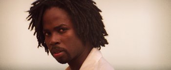 Movie still from “Romeo + Juliet” (1996), directed by Baz Luhrmann – A person with dreadlocks; Close Up shot, Low angle