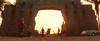 Movie still from “Romeo + Juliet” (1996), directed by Baz Luhrmann – A group of people standing in front of an opening in a building; Extreme Wide shot, Low angle