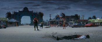 Movie still from “Romeo + Juliet” (1996), directed by Baz Luhrmann – A group of people standing on the street near a building; Extreme Wide shot, High angle