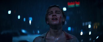 Movie still from “Romeo + Juliet” (1996), directed by Baz Luhrmann – A young man with blood all over his face; Close Up shot, Low angle