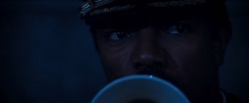 Movie still from “Romeo + Juliet” (1996), directed by Baz Luhrmann – A man's eyes and mouth; Extreme Close Up shot, Over the shoulder angle