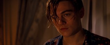 Movie still from “Romeo + Juliet” (1996), directed by Baz Luhrmann – A person with wet hair; Close Up shot, Low angle
