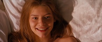 Movie still from “Romeo + Juliet” (1996), directed by Baz Luhrmann – A person smiling for the camera; Close Up shot, Overhead angle